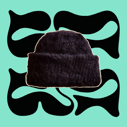 Hand-Knitted Black Mohair Beanie with Fold-Over Cuff on Green Background